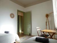 a bedroom with a green door and a chair at Les 3 Graces, Cayeux-sur-mer, agréable maison in Cayeux-sur-Mer