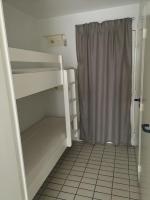 a small room with a bunk bed and a shower at Résidence arc en ciel, proche de la plage accés direct ,internet et parking privatif gratuit in La Grande Motte