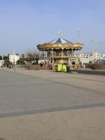 a large wooden gazebo in a parking lot at Résidence arc en ciel, proche de la plage accés direct ,internet et parking privatif gratuit in La Grande Motte