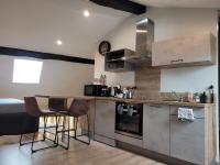 a kitchen with a table and chairs in a room at Studio au centre-ville in Saint-Jean-de-Losne