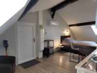 a room with a white door in a attic at Studio au centre-ville in Saint-Jean-de-Losne