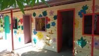 a play house with a door and flowers painted on it at Pousada Grão in Belém