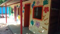 a house painted with flowers on the side of it at Pousada Grão in Belém