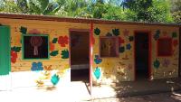 a house with colorful doors and windows with at Pousada Grão in Belém