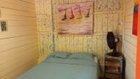 a bedroom with a bed and a painting on the wall at Pousada Grão in Belém