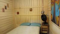 a room with a bed in a wooden room at Pousada Grão in Belém