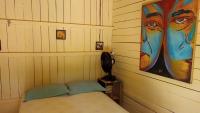 a bedroom with a bed and a painting on the wall at Pousada Grão in Belém