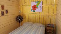 a corner of a room with a bed in a room at Pousada Grão in Belém
