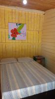 a bedroom with a bed with a painting on the wall at Pousada Grão in Belém
