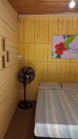 a small room with a bed and a table at Pousada Grão in Belém