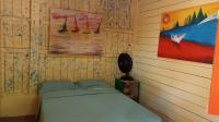 a bedroom with a bed and a painting on the wall at Pousada Grão in Belém