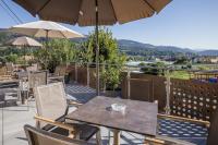 a table and chairs with an umbrella on a patio at Pension Ehrenfried - Hotel garni in Kindberg