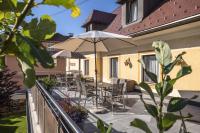 a patio with tables and chairs and an umbrella at Pension Ehrenfried - Hotel garni in Kindberg