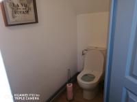 a bathroom with a toilet and a picture on the wall at Studio grand lit 160 tout équipé wifi in Le Creusot