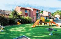 a playground with a slide in a yard at Pavillon, de 4 à 7 couchages, dans une superbe résidence avec piscine in Soustons