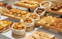 a bunch of different types of bread and pastries on display at NH Collection Marseille in Marseille