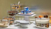 a buffet with bowls of food and other food items at NH Collection Marseille in Marseille