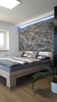 Postel nebo postele na pokoji v ubytování Vila Věkoše - apartmán s terasou a zahradou