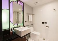 a bathroom with a sink and a toilet and a mirror at OLAH Poshtel - Taichung Station in Taichung
