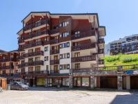 a tall apartment building with a car parked in front of it at Studio Rond Point des Pistes-19 by Interhome in Tignes