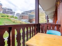 a wooden table on a balcony with a view at Studio Rond Point des Pistes-19 by Interhome in Tignes