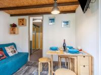 a living room with a table and a blue couch at Studio Rond Point des Pistes-19 by Interhome in Tignes