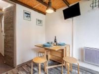 a small dining room with a table and stools at Studio Rond Point des Pistes-19 by Interhome in Tignes