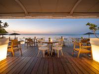 a restaurant with tables and chairs on a deck at Golden Star City Resort in Perea