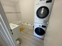 a washer and dryer in a small room at Appartement Charmant Cocon Plus in Croix