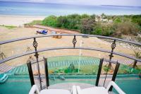 a balcony with a view of a beach and the ocean at Ibizakenting Hotel in Kenting