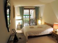 a bedroom with a large bed and a balcony at 2P 4* 58m2 face au Lac in Aix-les-Bains
