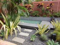 a garden with a swimming pool and some plants at Kenting Amanda Hotel in Nanwan