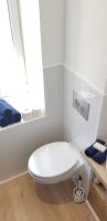 a white bathroom with a toilet and a window at Escapade Niortaise - Studios climatisés hyper-centre de Niort in Niort