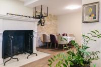 a living room with a fireplace and a dining table at Carpe Diem in Sladka Voda