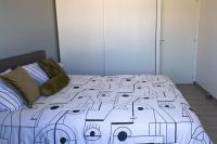 a bed with a face drawn on it in a bedroom at VILLA avec PISCINE chauffée trois chambres in Saint-Sulpice-de-Royan