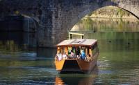 a small boat in the water under a bridge at Casita Néracaise in Nérac