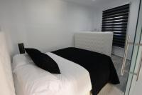 A bed or beds in a room at Apartamentos Torrecilla
