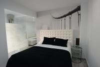 A bed or beds in a room at Apartamentos Torrecilla