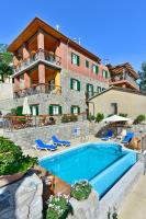 a house with a swimming pool in front of a building at Vasilikis House in Kalopanayiotis