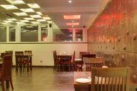a dining room with tables and chairs in a restaurant at Hotel Grand Godwin -Near Connaught Place- Free Airport Pick-Up in New Delhi