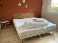 a bedroom with a bed with white sheets on it at Nouveau !! Bel appartement à Fécamp tout près de la plage, gare et voie verte in Fécamp
