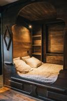 a bedroom with a large bed in a wooden room at Chalet Camillou in Champagny-en-Vanoise