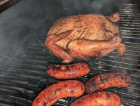 a chicken and some sausages on a grill at KoKo Palm Inn LTD in Accra