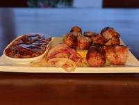 a plate of food with meat and beans and a sandwich at KoKo Palm Inn LTD in Accra