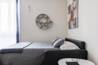 A bed or beds in a room at JOIVY Superb Flat with Home Office