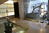 a lobby with a tree in the middle of a building at City Suites-Taipei Nanxi in Taipei