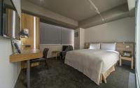 a hotel room with a bed and a desk at Simple + Hotel in Taipei