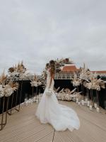 a woman in a wedding dress standing on a deck at WERK Hotel & SPA in Hunedoara
