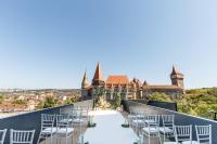 a balcony with chairs in front of a castle at WERK Hotel & SPA in Hunedoara