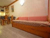 a bedroom with a wooden bed in a room at Appartement Les Menuires, 2 pièces, 4 personnes - FR-1-452-253 in Les Menuires